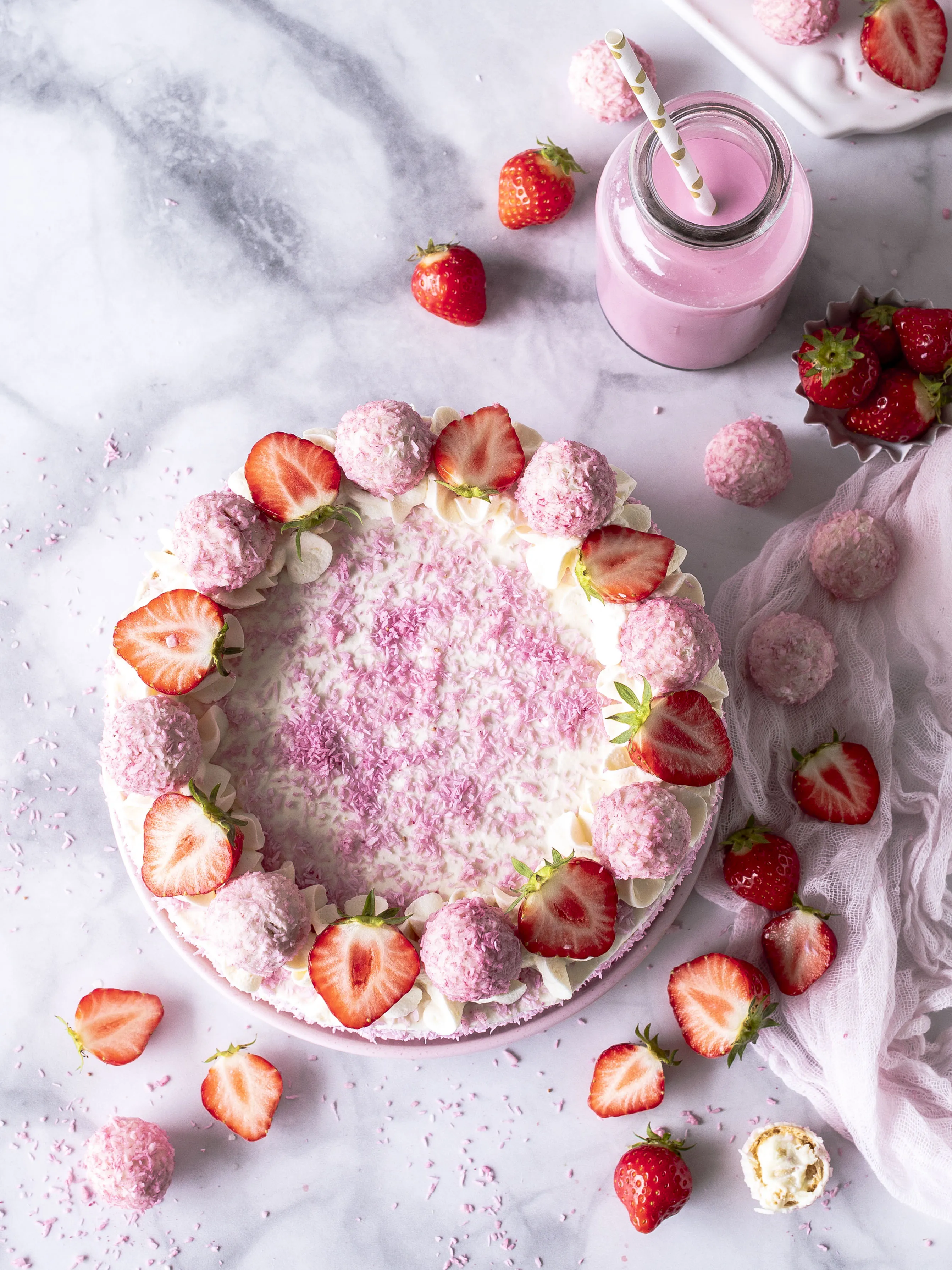 Schnittansicht einer Erdbeer Kokos Torte mit Cremeschichten und Erdbeeren