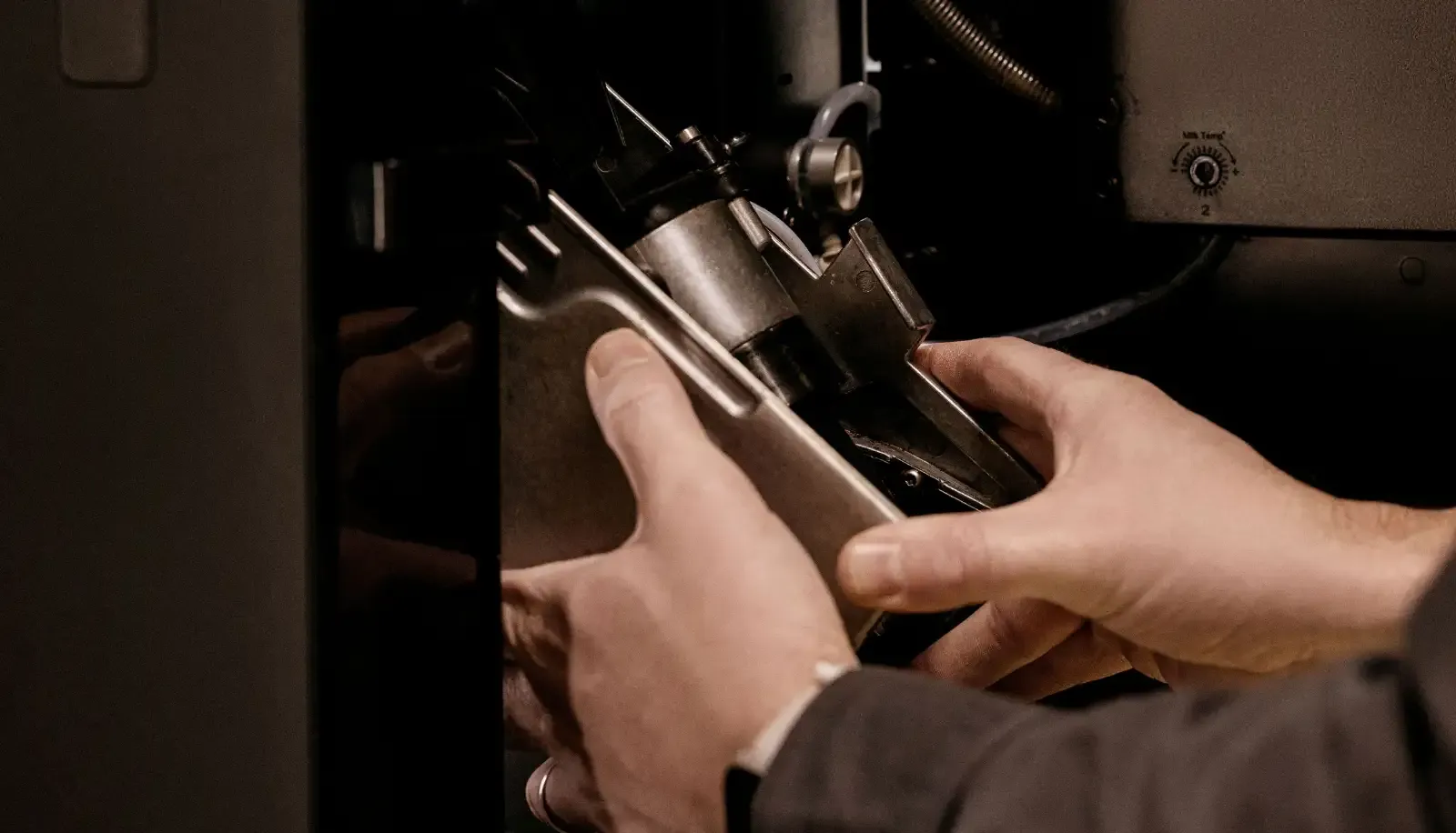 Techniker wartet eine Brühgruppe eines Kaffeevollautomaten