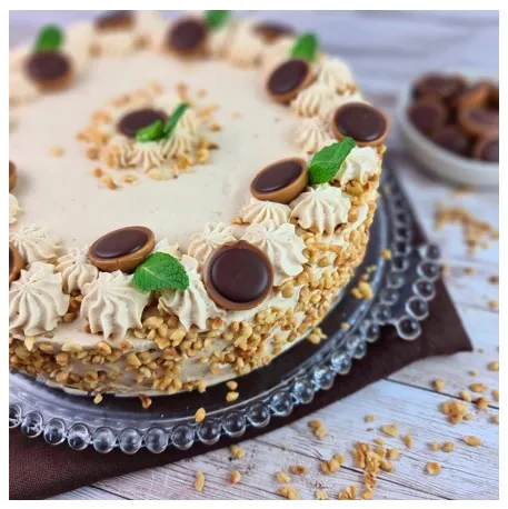 Toffifee Torte von der Seite mit Toffifee und Haselnüssen