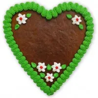 Verziertes Lebkuchenherz mit grünem Rand und Zuckerdekoration