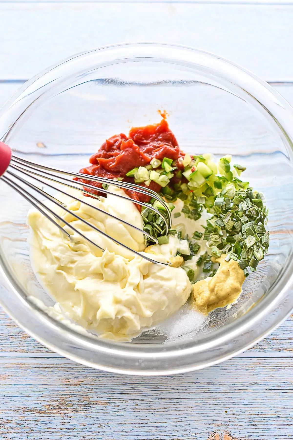 whisking low FODMAP special sauce ingredients together in a small glass bowl